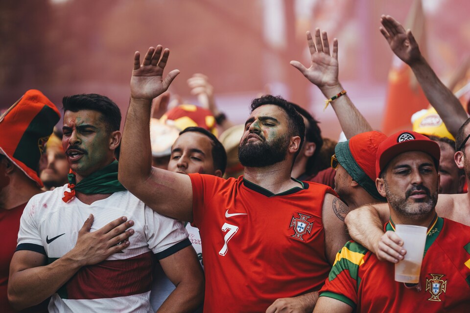 Portugal national football team fans waving red and green flags in the stadium stands at World Cup 2026.